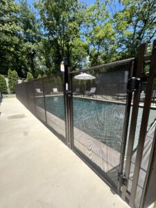 Nashville pool safety company installing a child-safe pool fence with self-closing and self-locking gate
