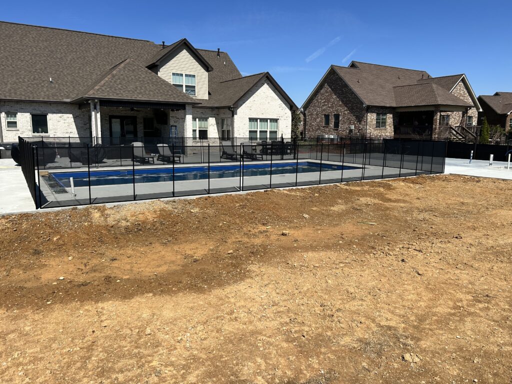 “Finished pool safety fence surrounding a backyard pool in Smyrna, Tennessee”